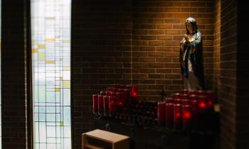 Our Lady statue with candles