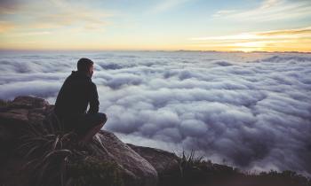 man contemplating clouds make God priority #1